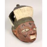 A PAINTED TRIBAL MASK 13ins long.