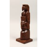 GEOFREY HUNT. A CARVED WOOD TOTEM POLE Signed 12ins high.