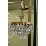 A brass and cut glass small chandelier.