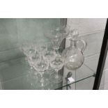 A glass claret jug with engraved vine leaf decoration together with a similar pedestal bowl and