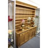 A 19th century pine dresser with Delft rack, the base with two drawers and two cupboard doors.