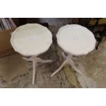 A pair of white painted tripod tables.