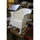 A Lloyd Loom style rocking armchair.