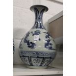 A large Chinese blue and white vase decorated with dragons chasing the pearl of wisdom.