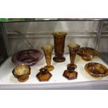 Moulded brown tinted glass bowls and vases and a pair of candlesticks.