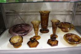 Moulded brown tinted glass bowls and vases and a pair of candlesticks.