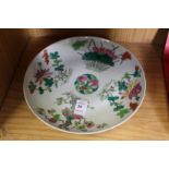 A Chinese circular dish painted with flowers, prunus tree etc.