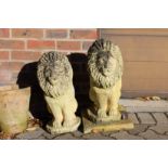 A pair of reconstituted stone figures of lions rampant.