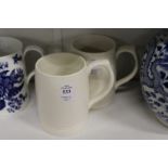 A pair of Keith Murray for Wedgwood pottery tankards.