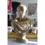 A painted plaster bust of Julius Caesar.