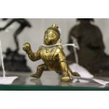 A small eastern bronze figure of baby Ganesh.