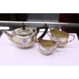 A small three-piece oval silver tea set comprising teapot, sugar basin and milk jug, 13ozs.