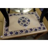 An inlaid marble table top with stand.