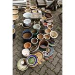 A large quantity of small garden pots and pot stands etc.