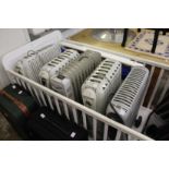 Five various oil filled electric portable heaters.