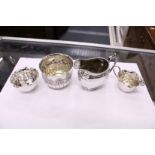A group of small silver items to include a milk jug, a small cream jug and matching sugar bowl and