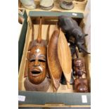 A carved African mask and similar items to include a rhinoceros.