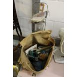 An old army bag containing miscellaneous items together with a camping gas bottle and similar lamp.