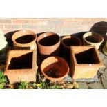 A small collection of terracotta plant pots.