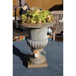 A small cast iron garden urn.