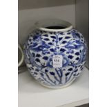 A Chinese blue and white jar painted with dragons.