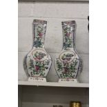 A pair of Chinese floral decorated baluster shaped vases.
