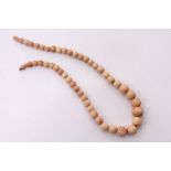 A stained ivory bead necklace.