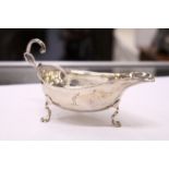 A small silver sauce boat.