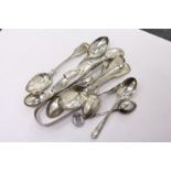 A pair of silver sugar tongs, various spoons.