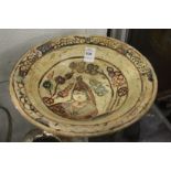 Decorative painted and incised Islamic pottery bowl.