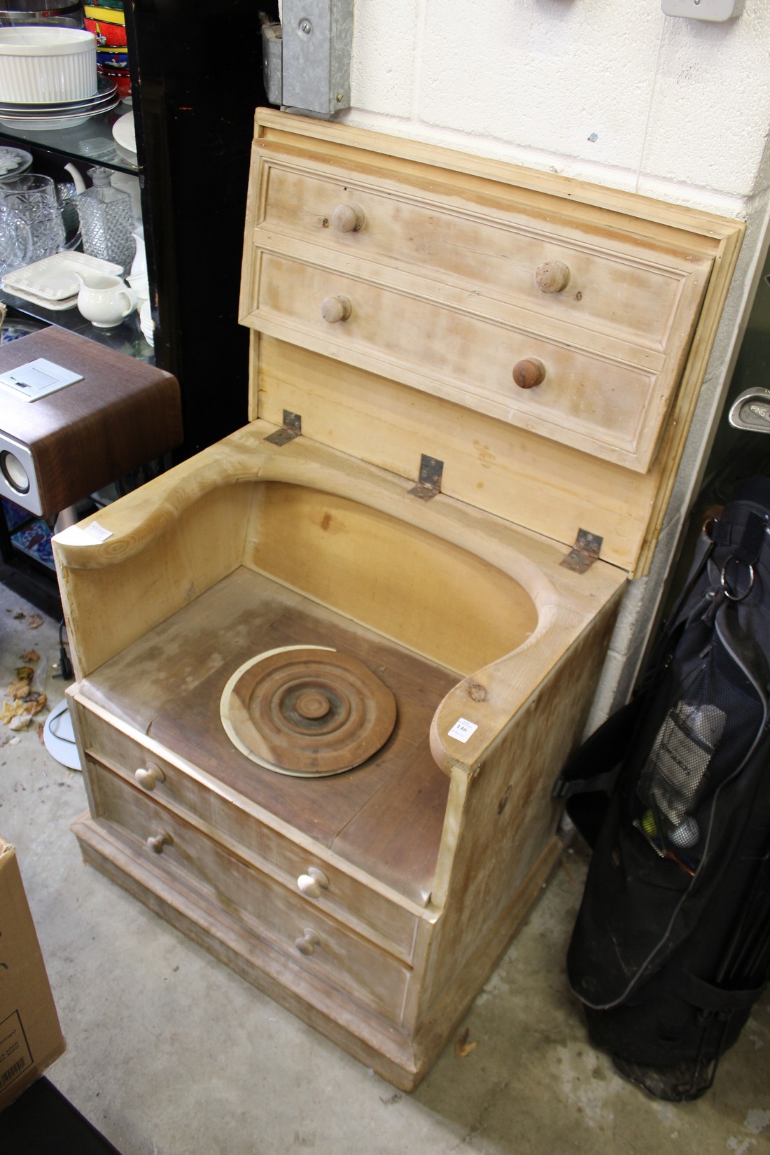 An old commode with lifting lid and original liner.