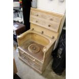 An old commode with lifting lid and original liner.