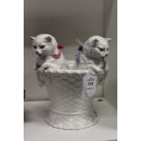 An unusual white porcelain vase modelled as two kittens climbing out of a basket.
