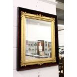 A decorative gilt framed mirror contained in a velvet lined case.