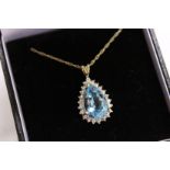 A 9ct gold diamond and blue stone pear shaped pendant and chain.