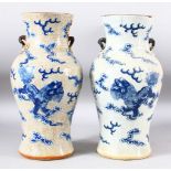 A PAIR OF CHINESE BLUE AND WHITE CRACKLE GLAZE TWIN HANDLE VASES, the body of each painted with