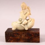 A 19TH CENTURY CHINESE CARVED SOAPSTONE OF A BOY RIDING A BEAST, the boy seated upon the back of a