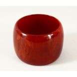 A GOOD ISLAMIC BAKELITE CHERRY AMBER BANGLE - 6cm opening