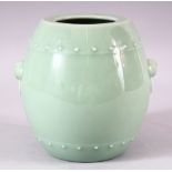 A CHINESE PALE CELADON GROUND BARREL SHAPE VASE, with pair of moulded mask handles, mark to base,