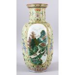 AN 18TH/19TH CENTURY CHINESE FAMILLE VERTE PORCELAIN VASE, painted with two panels of mountainous