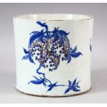 A CHINESE BLUE, WHITE & IRON RED PORCELAIN BRUSH POT - decorated with tree blooms, the base with a
