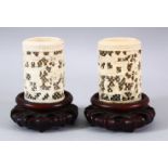 A PAIR OF 19TH CENTURY CHINESE CANTON CARVED IVORY OPENWORK VASES & STANDS - decorated with scenes