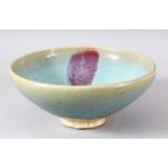 A CHINESE JUNYAO GLAZED POTTERY BOWL, 23.5cm diameter.