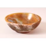 A CHINESE SMALL CARVED AGATE CIRCULAR BOWL, 9cm diameter.