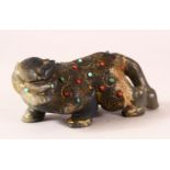 AN INDIAN CARVED AND GILDED INLAID JADE FIGURE of a buffalo, in a prowling pose, inset with