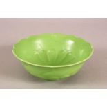 A CHINESE GREEN GLAZED LOTUS FORMED PORCELAIN PETAL DISH - with moulded petal lower section - the