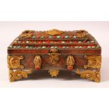 A TIBETAN MOUNTED AND INLAID METAL CASKET, the body with openwork style inlay, with gilt raised