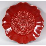 A CHINESE COPPER RED LOBED PORCELAIN DRAGON BOWL - interior decorated with the face of a dragon -