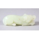 A CHINESE CARVED CELADON JADE PENDANT OF A DOG / BEAST - in a recumbent pose - 7.5cm