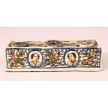 A GOOD PERISAN QAJAR POTTERY INKWELL - with floral decoration and removable wells - 20cm wide